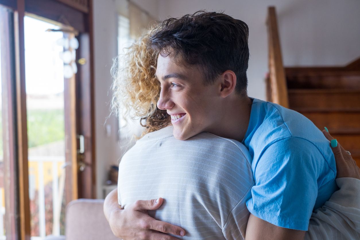 teenage son hugging his mom