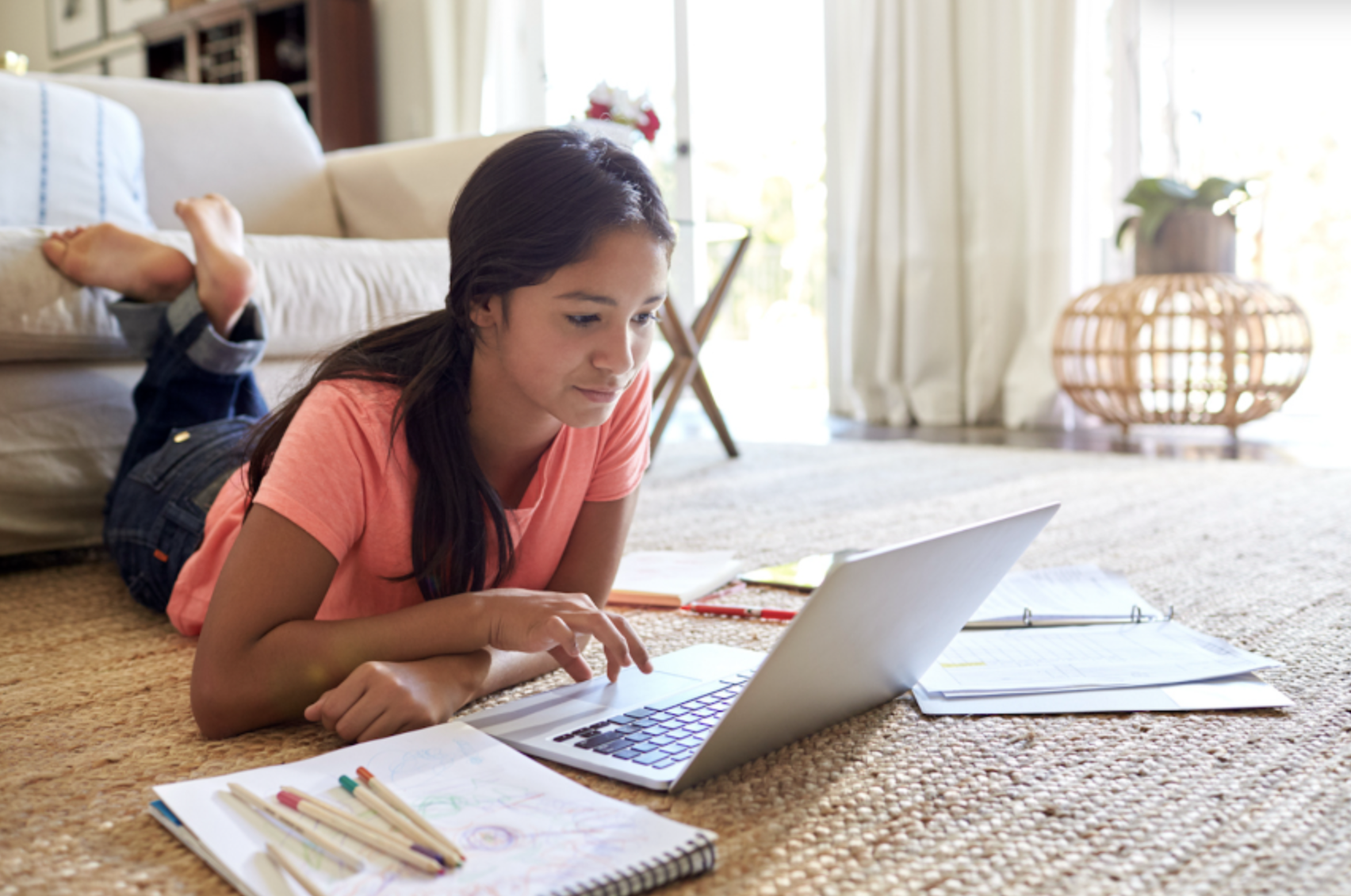 happy teen daughter on her computer at home.