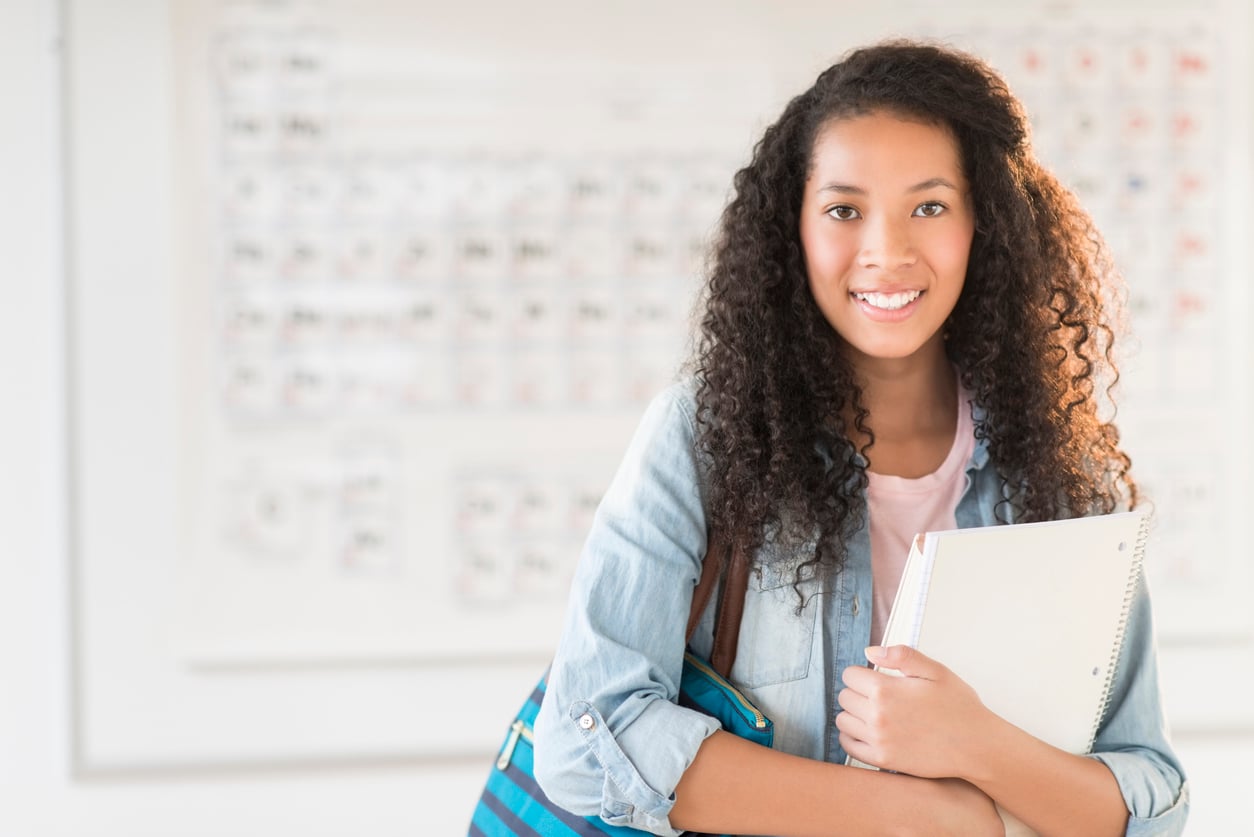 Student smiling with notebook