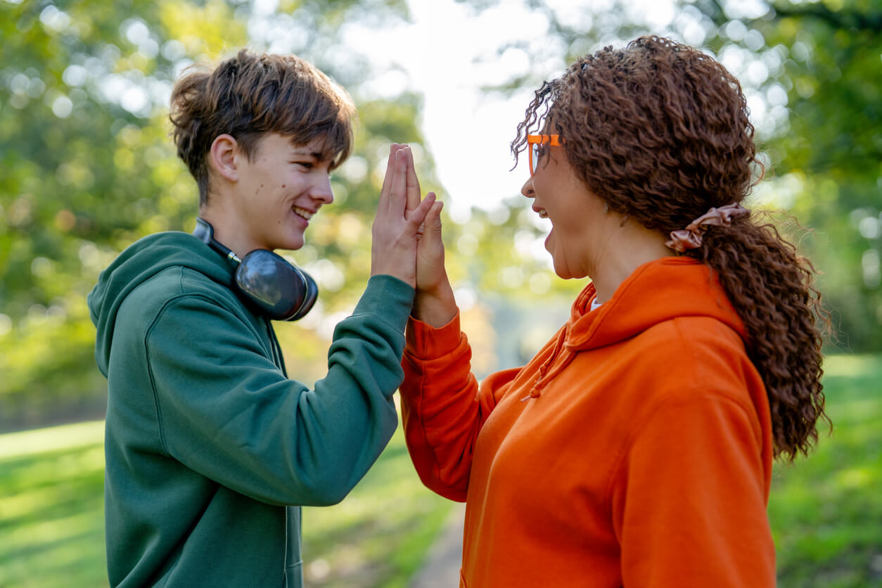 Male and Female Student Giving a High Five
